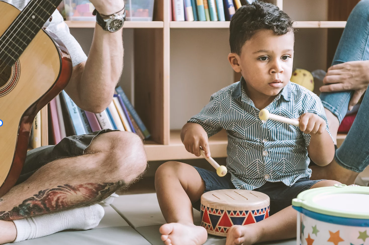 The Power Of Music In Education - Playing drums with a child